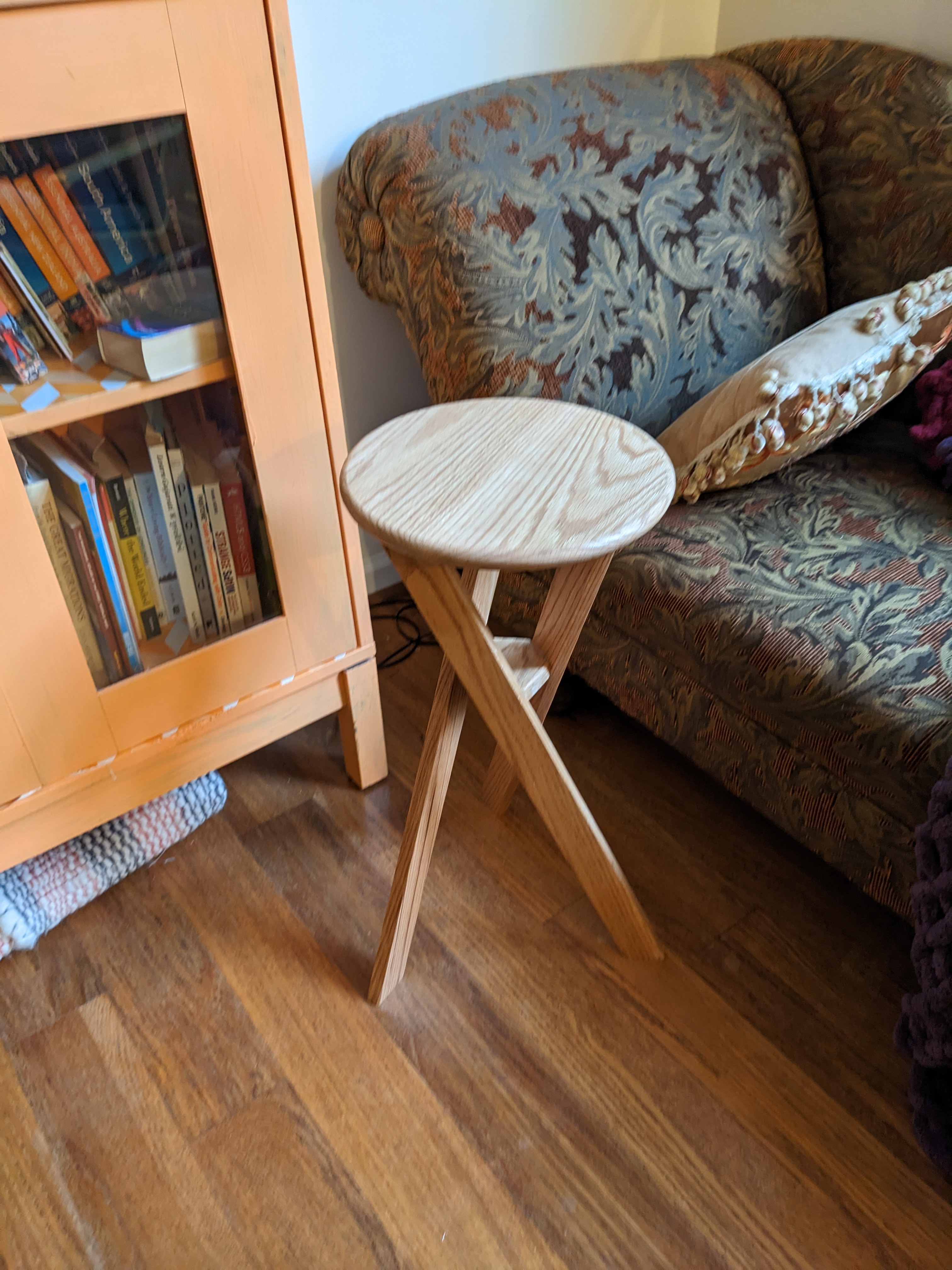 A round side table with three angular legs